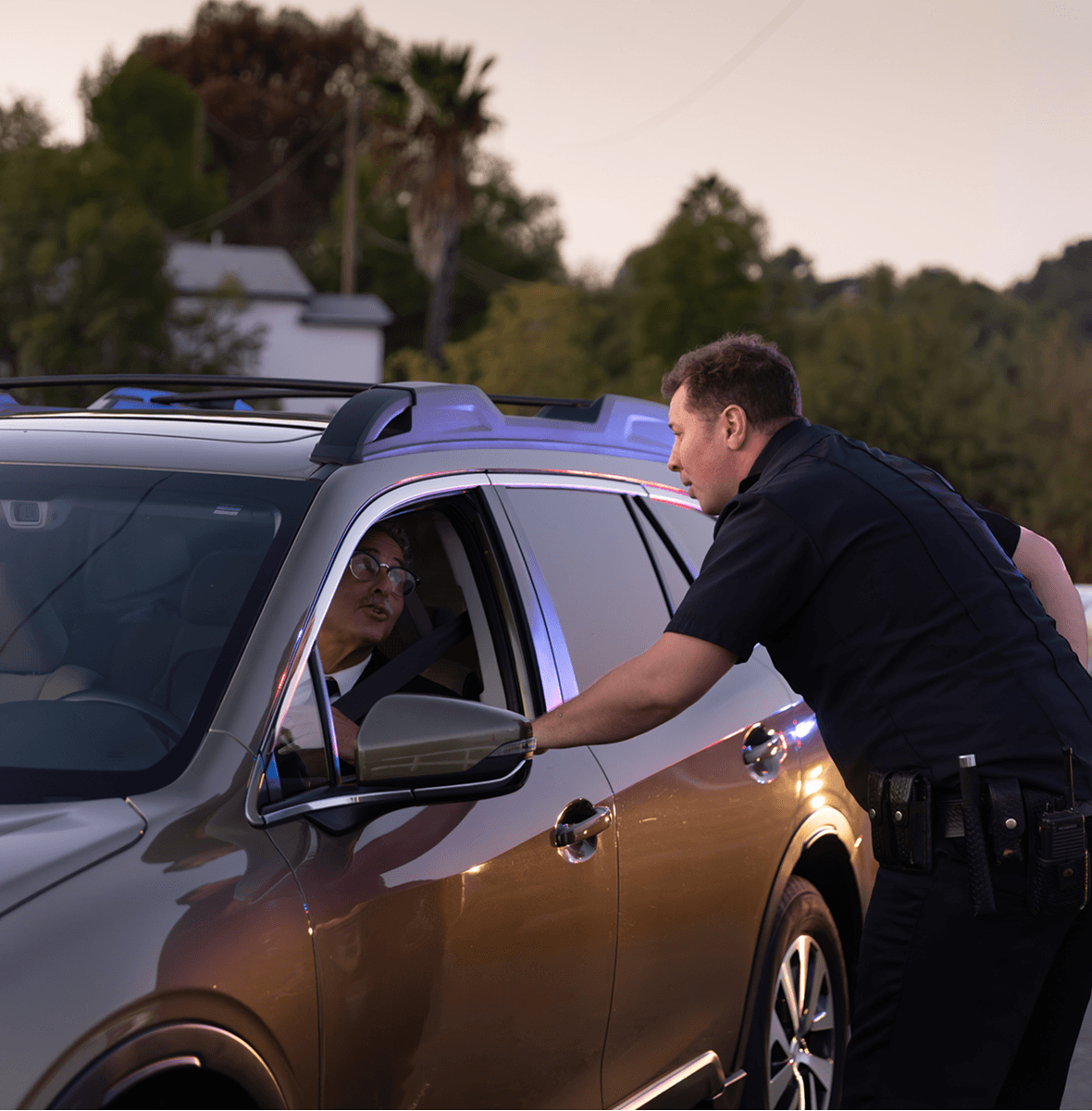 Police officer talking to car driver