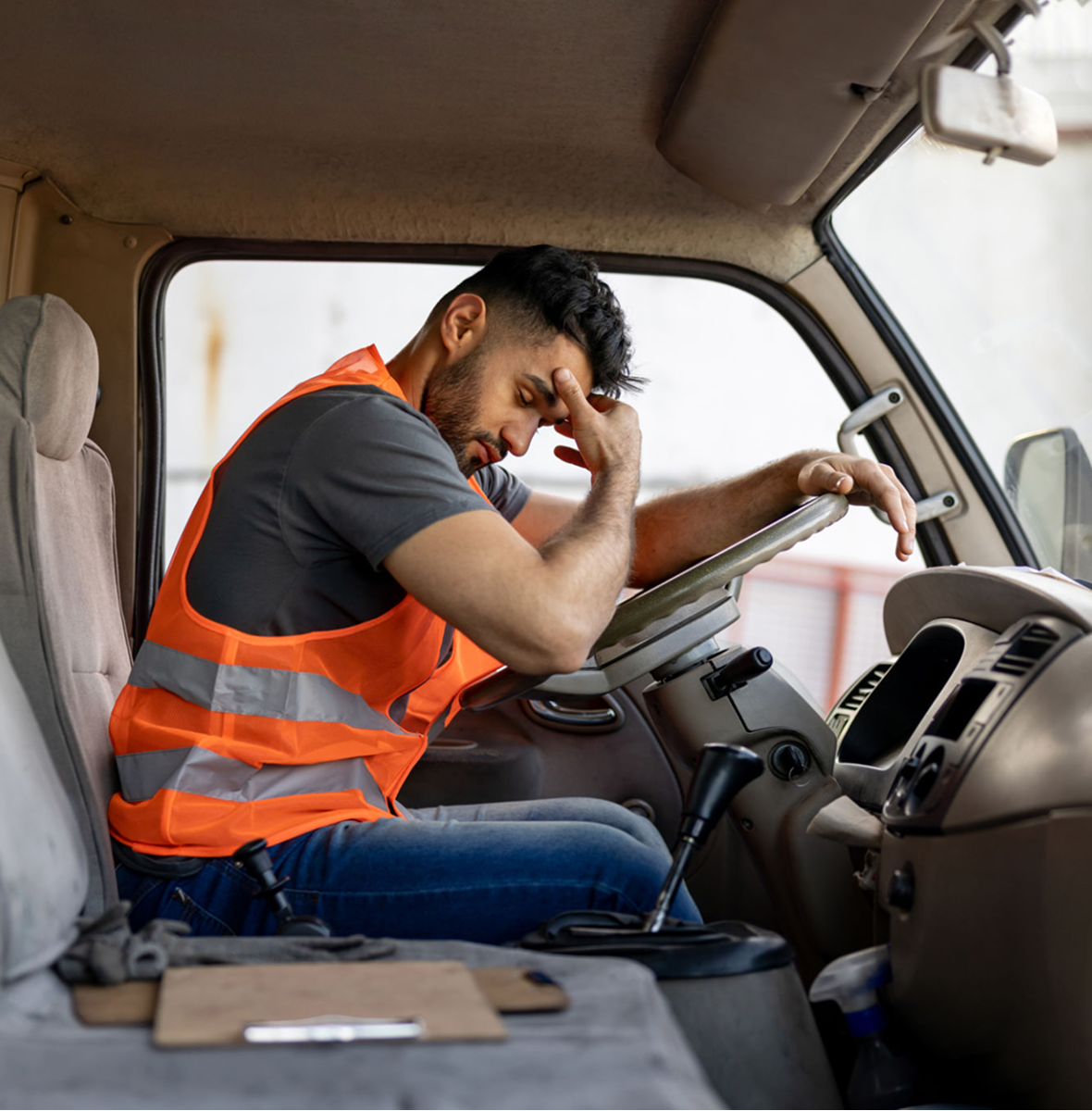 Tired driver in orange safety vest