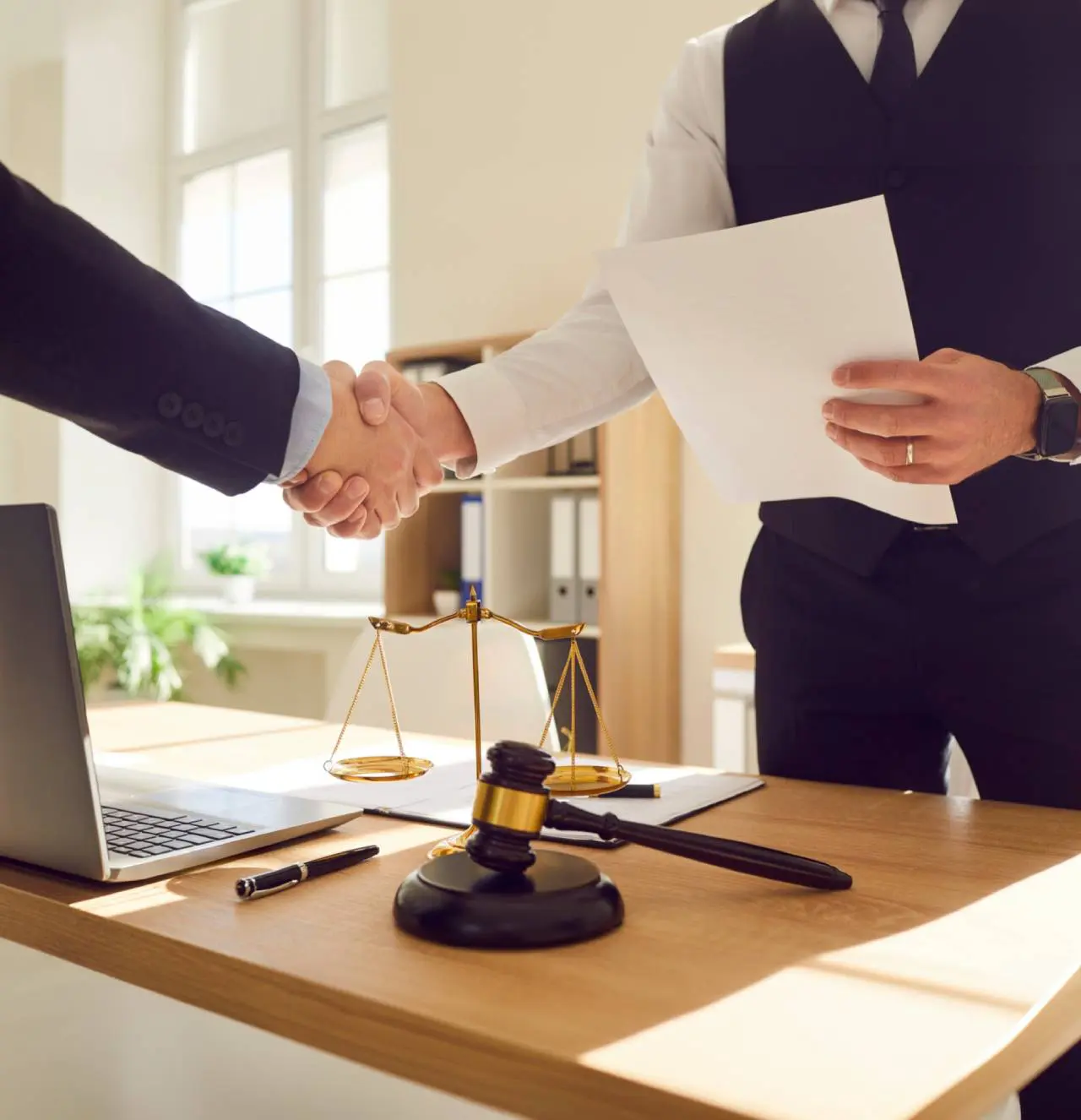 Lawyer and client shaking hands over agreement